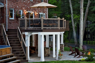 Example of a large classic backyard patio design in Other with no cover