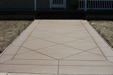Backyard concrete paver patio photo in Los Angeles with no cover