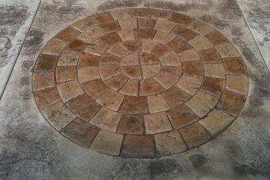 Mid-sized backyard concrete paver patio photo in Vancouver with no cover