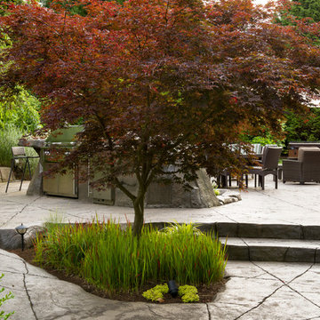 Concrete Patio with Outdoor Kitchen, Seating Area and Hot Tub in Surrey