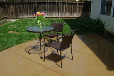 Inspiration for a mid-sized timeless backyard concrete patio remodel in San Francisco with a roof extension