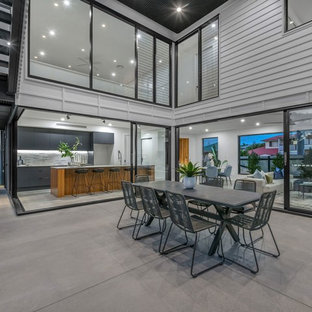 This is an example of a contemporary courtyard patio in Brisbane with concrete slab and a roof extension.