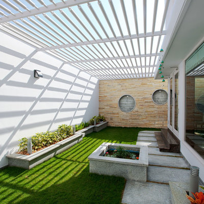 Patio - contemporary concrete paver patio idea in Other with a pergola