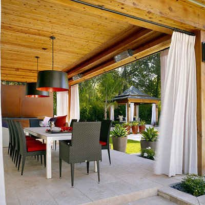 Patio - contemporary patio idea in London with a pergola
