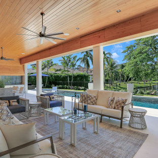 Patio kitchen - huge contemporary backyard patio kitchen idea in Miami with a roof extension