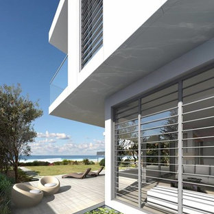 Ispirazione per un patio o portico design di medie dimensioni e dietro casa con graniglia di granito e nessuna copertura