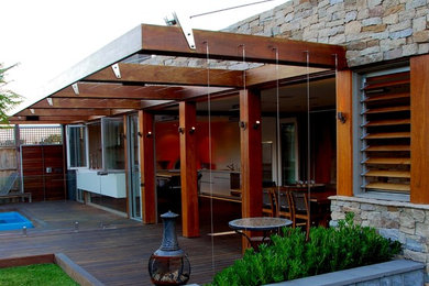 Photo of a medium sized contemporary back patio in Melbourne with a fire feature, decking and a pergola.