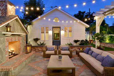 Patio - small coastal backyard tile patio idea in San Diego with a fire pit and no cover