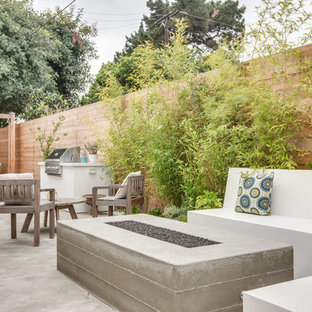 Trendy patio photo in Orange County with a fire pit