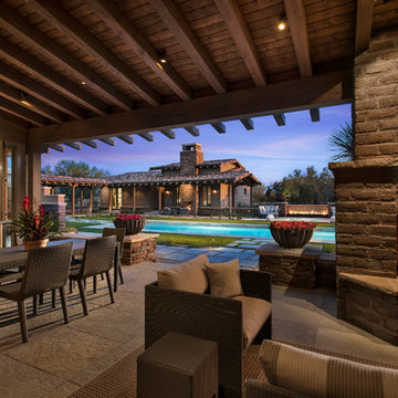 Covered patio with adobe fireplace, Casita sits on the other side of the pool.