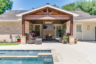 Photo of a traditional back patio in Houston with a roof extension.