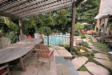 Inspiration for a timeless backyard patio remodel in Kansas City with a pergola