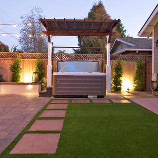 Esempio di un piccolo patio o portico american style dietro casa con un caminetto, pavimentazioni in cemento e una pergola