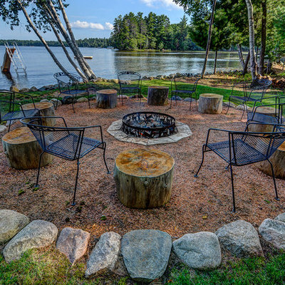Patio - rustic backyard patio idea in Other with a fire pit and no cover