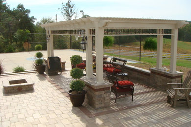 Inspiration for a mid-sized transitional backyard brick patio remodel in Cleveland with a pergola and a fire pit