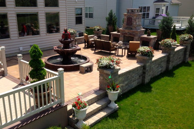 Large arts and crafts backyard brick patio photo in Cleveland with no cover and a fire pit