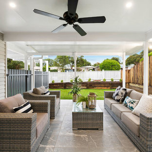 Mid-sized transitional front yard patio in Other with a container garden, tile and a roof extension.