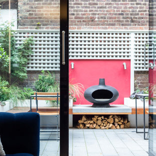 Design ideas for a contemporary back patio in Vancouver with a fireplace, concrete paving and no cover.