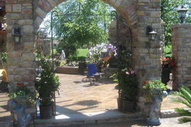 Elegant backyard stamped concrete patio photo in Cleveland with no cover