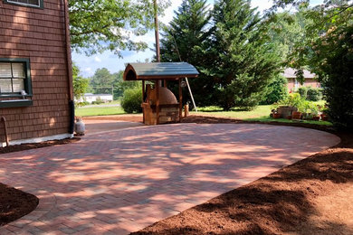 Inspiration for a large rustic backyard brick patio remodel in Richmond with no cover