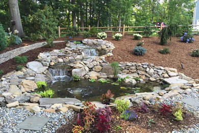 Design ideas for a large traditional backyard stone water fountain landscape in New York.