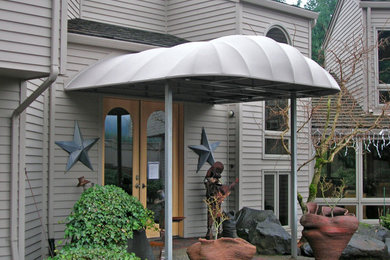 Inspiration for a small timeless front yard gravel patio remodel in Portland with an awning