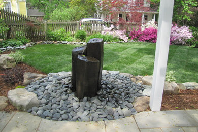 Inspiration for a mid-sized traditional backyard concrete paver water fountain landscape in DC Metro.