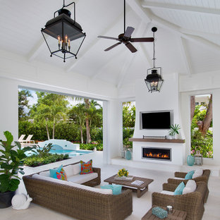 Example of a large beach style backyard patio kitchen design in Other with a roof extension