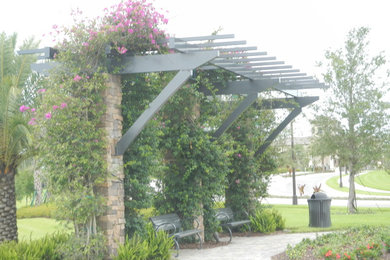 Patio - mid-sized traditional backyard tile patio idea in Tampa with a pergola