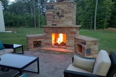 Example of a mid-sized classic backyard patio design in Other with a fire pit