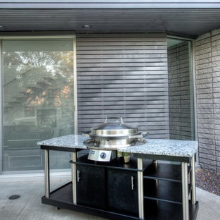 Patio kitchen - large contemporary backyard concrete patio kitchen idea in Other with no cover