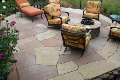 Inspiration for a timeless backyard concrete paver patio remodel in Denver with a fire pit and no cover