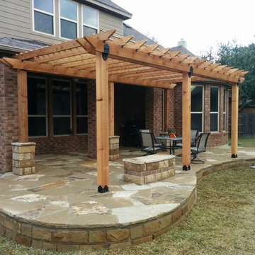 Custom mission style pergola with rock patio and benches