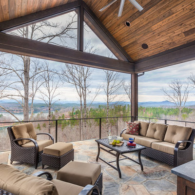 Patio - rustic patio idea in Other with a roof extension and a fireplace