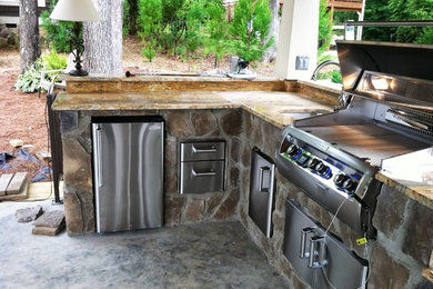 Patio kitchen - large traditional backyard stone patio kitchen idea in Atlanta with a gazebo