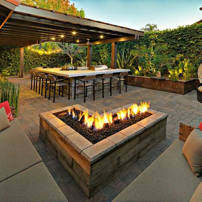 Inspiration for a small modern backyard brick patio kitchen remodel in San Diego with a pergola