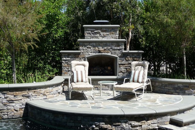 Patio - mid-sized traditional backyard stone patio idea in Orange County with a fire pit