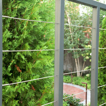 Custom steel and aircraft cable fence-trellis for vine tapestry