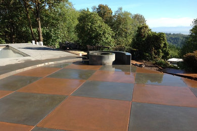 Large transitional backyard stamped concrete patio photo in Portland with a fire pit and no cover