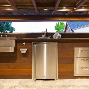 Example of a large trendy backyard stone patio kitchen design in Dallas with a pergola