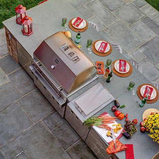 Patio kitchen - mid-sized cottage backyard patio kitchen idea in New York