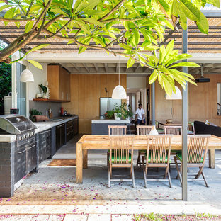 Design ideas for a beach style backyard patio in Sydney with an outdoor kitchen, concrete slab and a pergola.