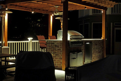 Mid-sized elegant backyard patio kitchen photo in Chicago with decking and a pergola