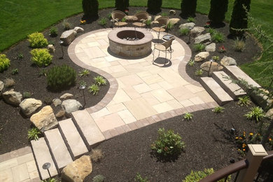 Inspiration for a large timeless backyard stone patio kitchen remodel in Philadelphia with a pergola
