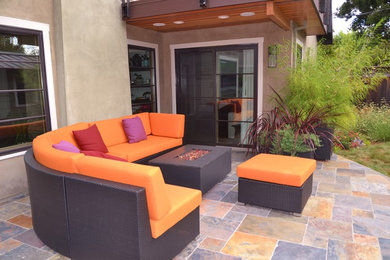 Large transitional backyard stone patio photo in San Francisco with no cover and a fire pit