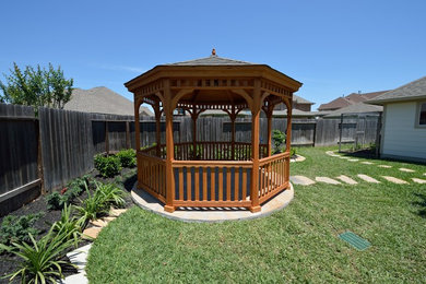 This is an example of a traditional back patio in Houston with a gazebo.