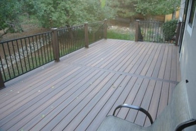 Example of a mid-sized backyard patio design in Denver with decking and no cover