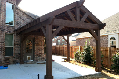 Inspiration for a mid-sized rustic backyard concrete patio remodel in Dallas with a gazebo