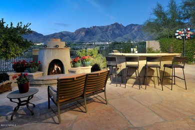 Patio kitchen - large transitional backyard stone patio kitchen idea in Phoenix with no cover