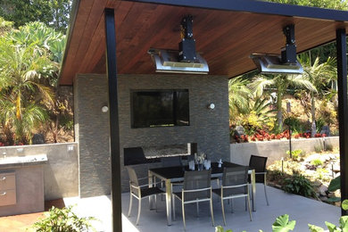 Patio - mid-sized contemporary backyard concrete paver patio idea in Los Angeles with a pergola